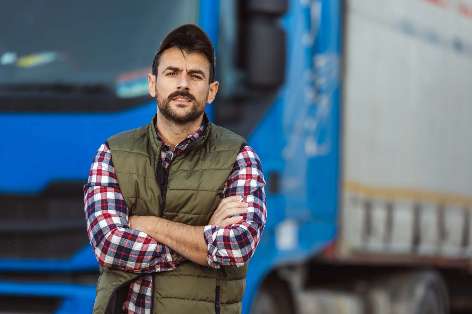 truck driver standing next to big rig